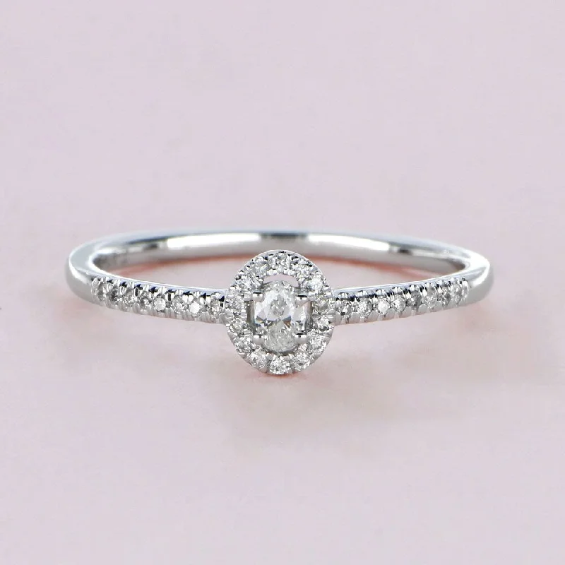 1/5ct TDW Oval Shape Diamond Halo Ring in 10k Gold by De Couer